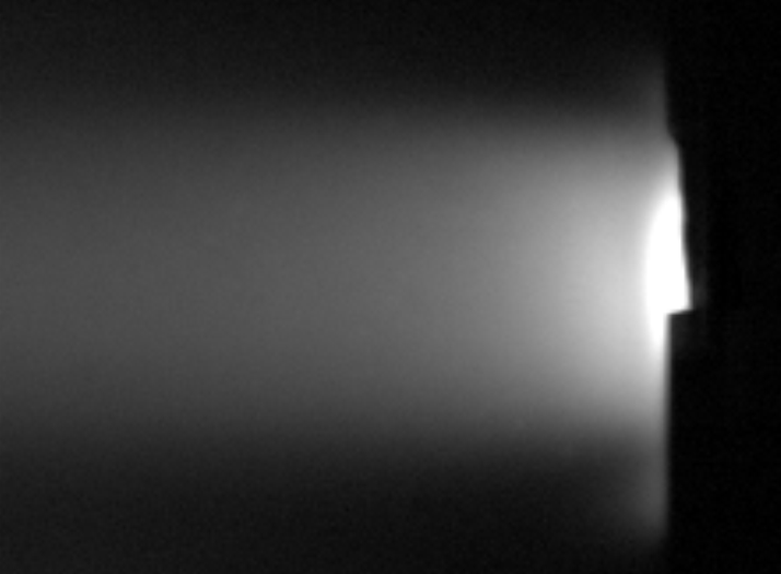 A tin surface exposed to a helium plasma. The bright tin vapour cloud radiates a fraction of the impinging plasma power away. Only light emitted by neutral tin (at 452.5 nm) is shown. 