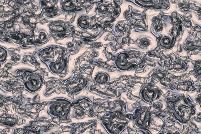 Jos Scholte used a 3D-printer from industrial partner Dunlee to create a capillary porous structure out of tungsten: a sponge for liquid metal. This microscope image shows smooth, solidified flows of the metal lying on top of the 3D-printed (ridged) tungsten. Credit: Jos Scholte
